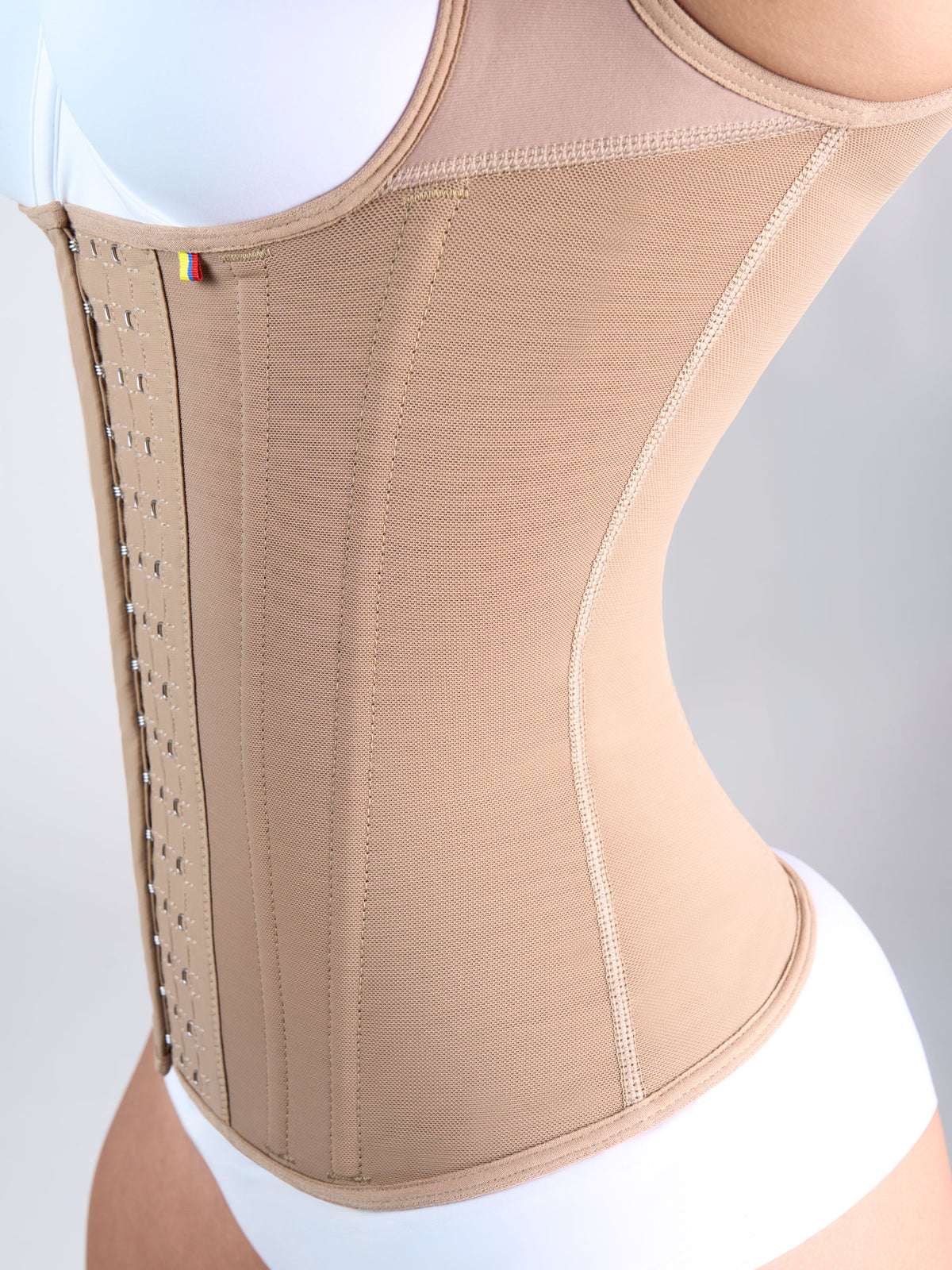 Close-up of the boning on the side and front of the mocha Shaping Vest, Colombian shapewear that offers back support and helps improve posture #color_Mocha
