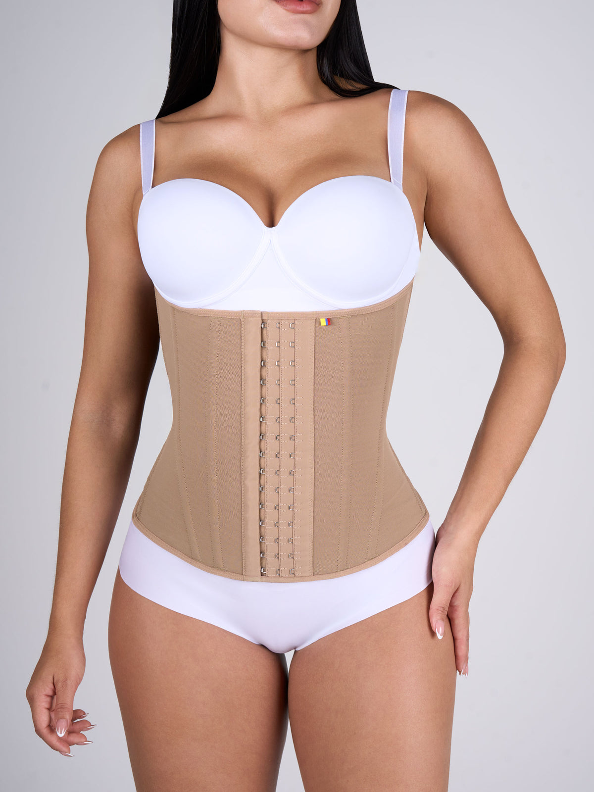 Woman wearing the mocha Waist Cincher, front-hook Colombian shapewear that defines the waist and slims the figure #color_Mocha