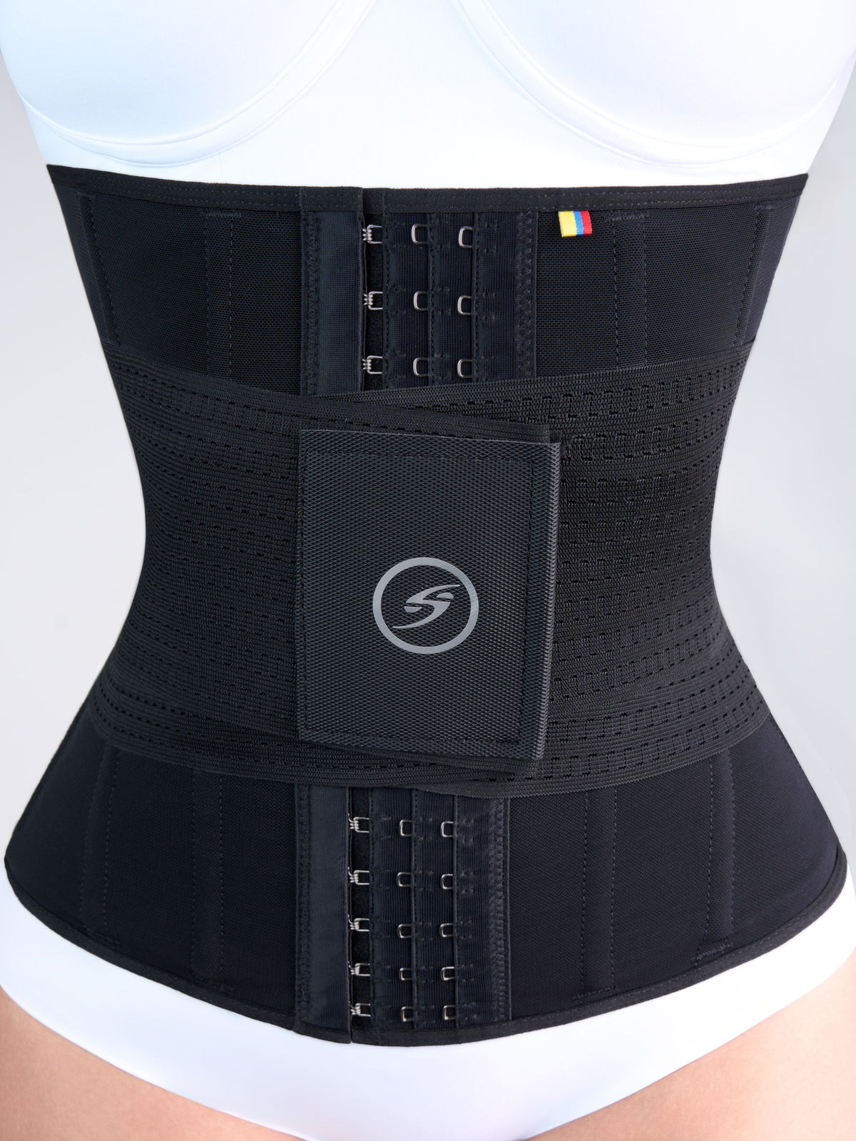 Close-up of the black Hourglass Waist Cincher with Elastics, Colombian shapewear with front hooks and a velcro band that shapes the waist and adds compression #color_Black