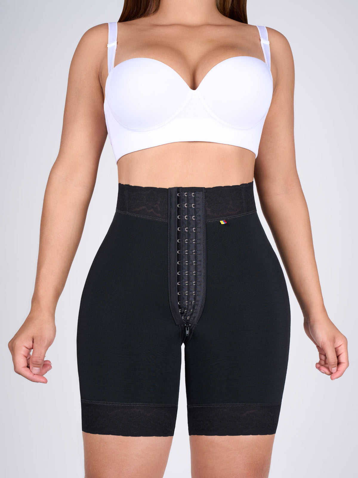 Front view of a woman wearing black high-waisted butt-lifting shorts, front-hook Colombian shapewear that defines the waist and shapes the hips #color_Black