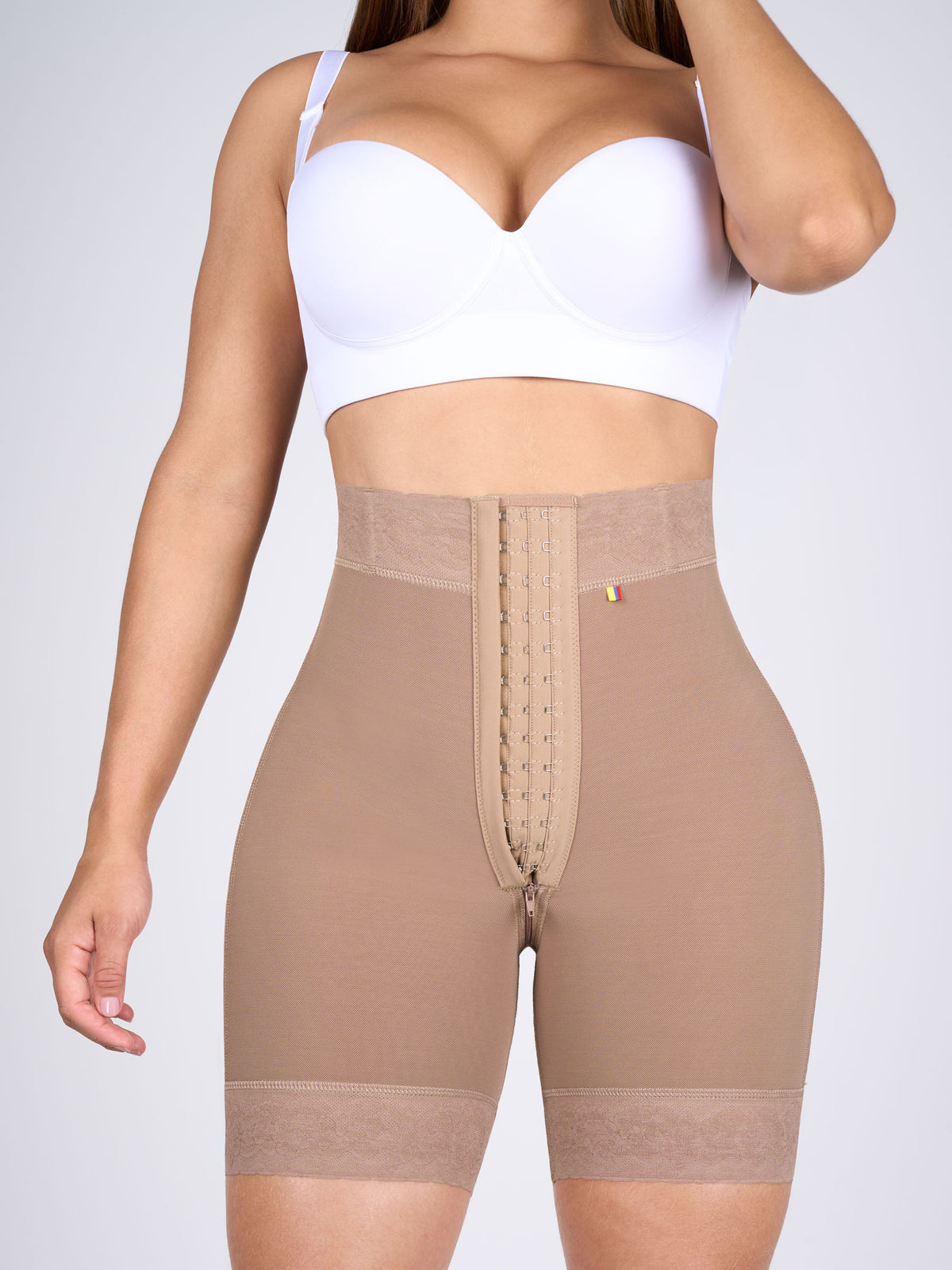 Front view of a woman wearing mocha high-waisted butt-lifting shorts, front-hook Colombian shapewear that defines the waist and shapes the hips #color_Mocha